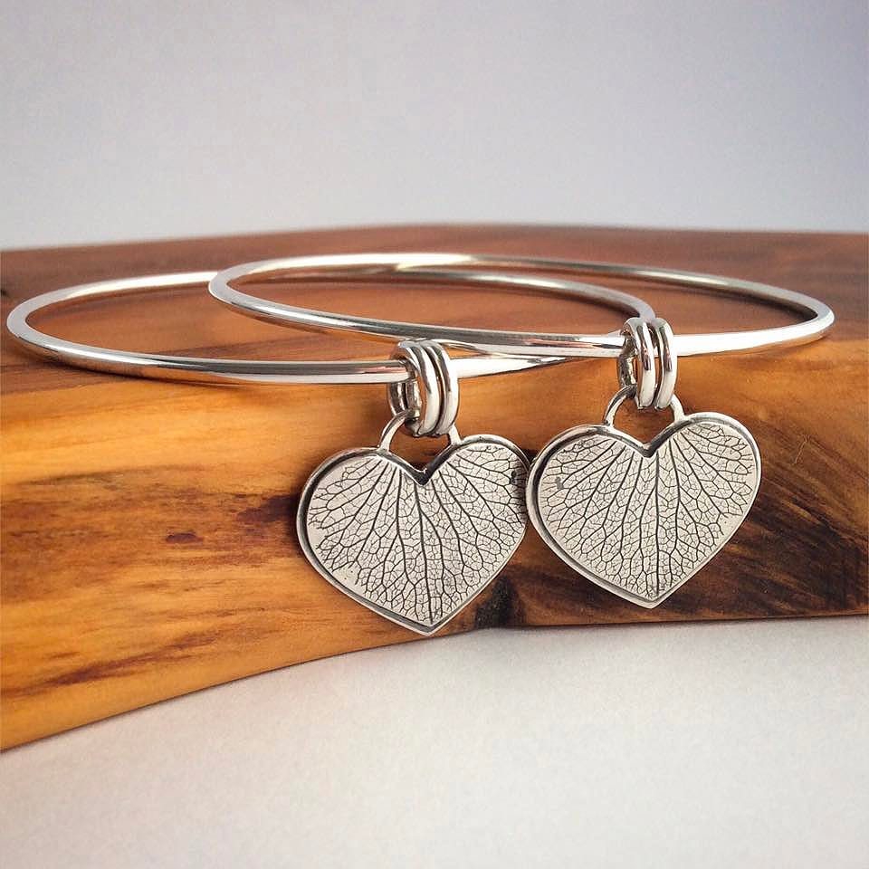 Handmade sterling silver bangle bracelet with copper heart