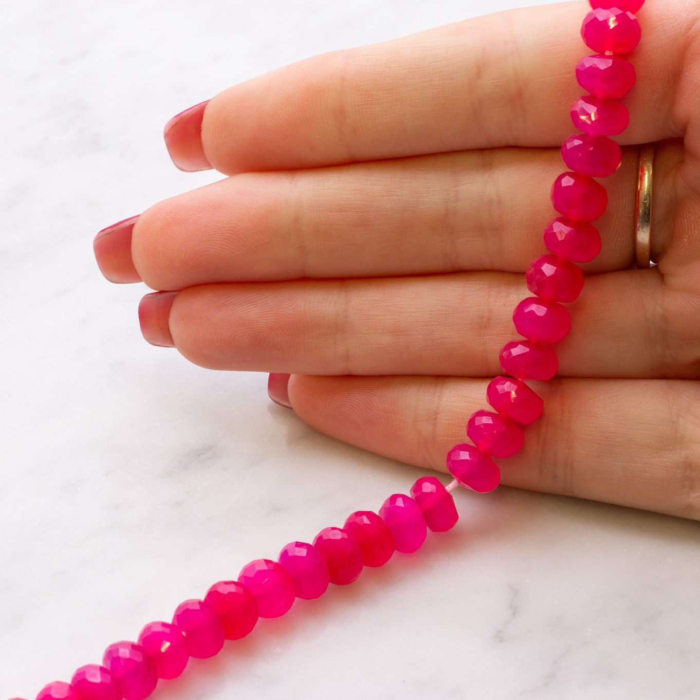 b447-fuchsia-pink-chalcedony-faceted-rondelle-beads-size-example-kernowcraft.jpg